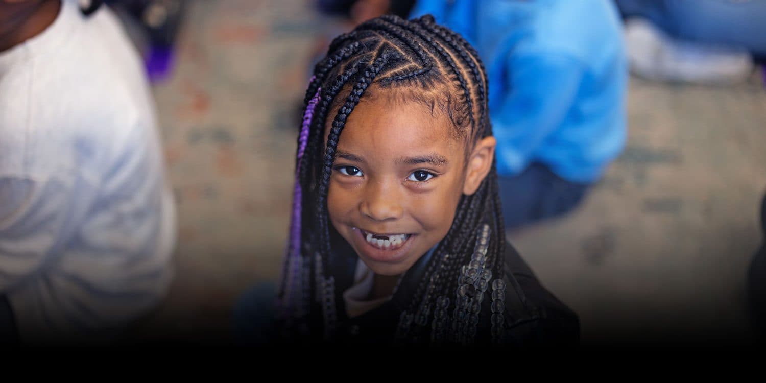 Smiling Northwest School of the Arts student with braided hair.