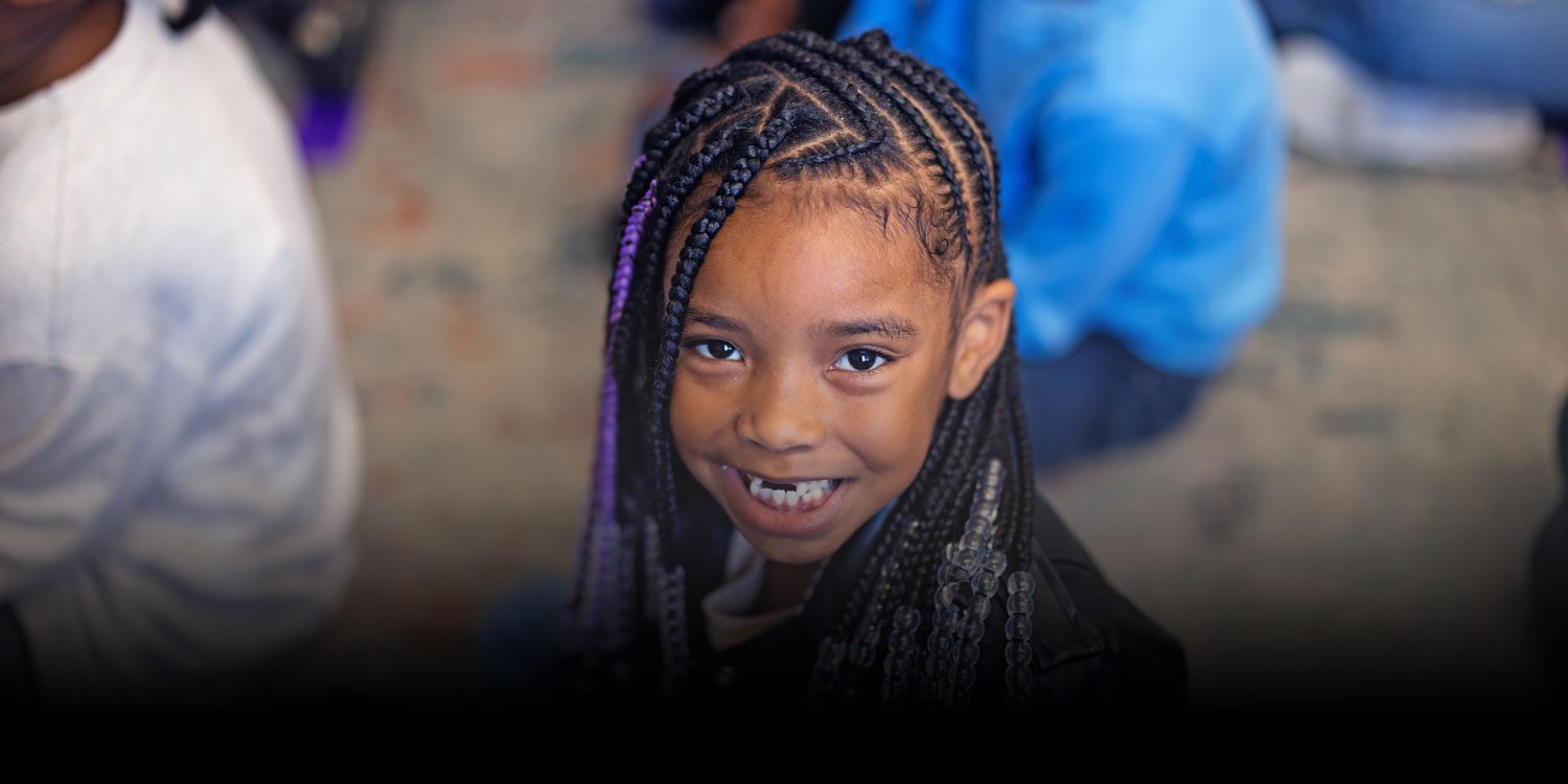 Smiling Northwest School of the Arts student with braided hair.