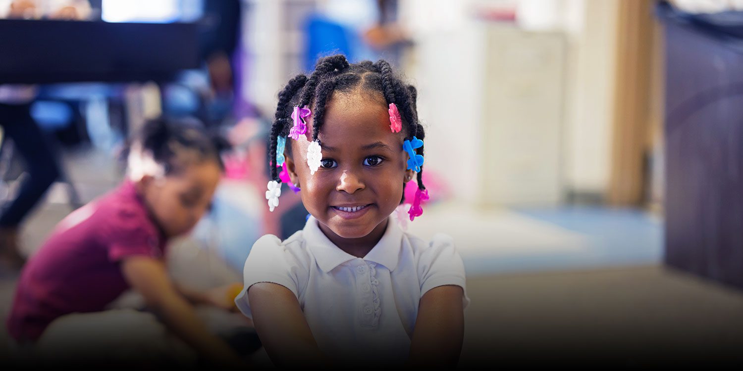 Smiling student in a classroom.